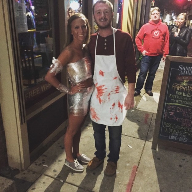 guy in a bloody apron with a girl in a sparkly dress