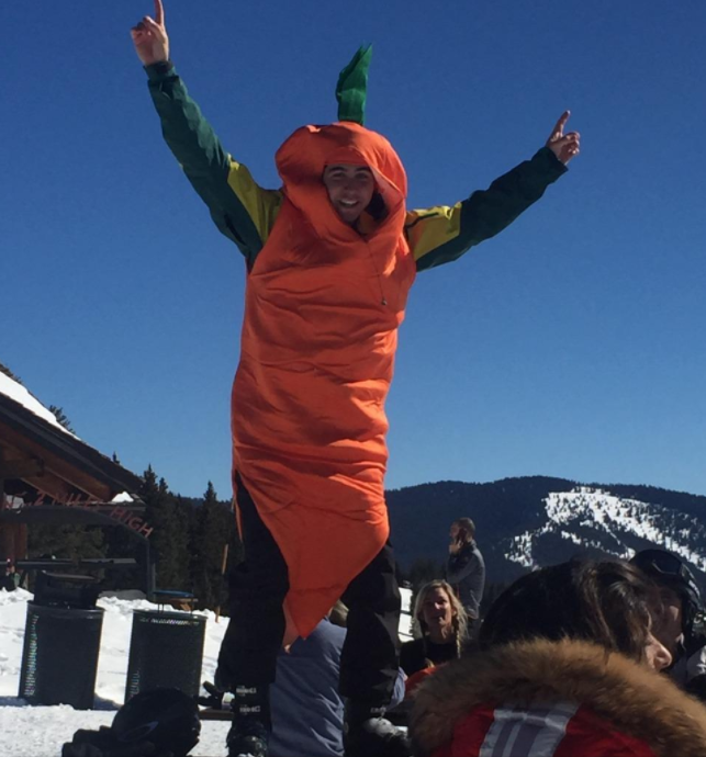 reviewer wearing an orange carrot suit