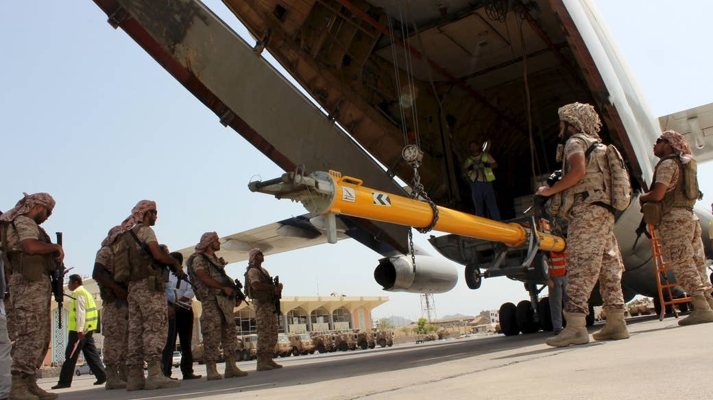 Soldiers from the United Arab Emirates stand guard as military equipment is unloaded from a UAE military plane at the airport in Aden, Aug. 12, 2015.