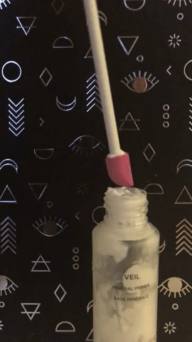 Animated gif of a hand using the spatula to get more primer out of the corners of a narrow-necked glass bottle