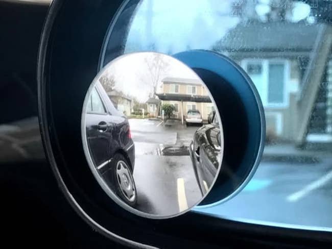 the circular mirror on a drivers window showing the blindspot