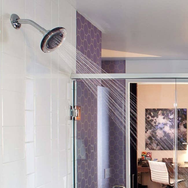 the purple showerhead in a model bathroom 