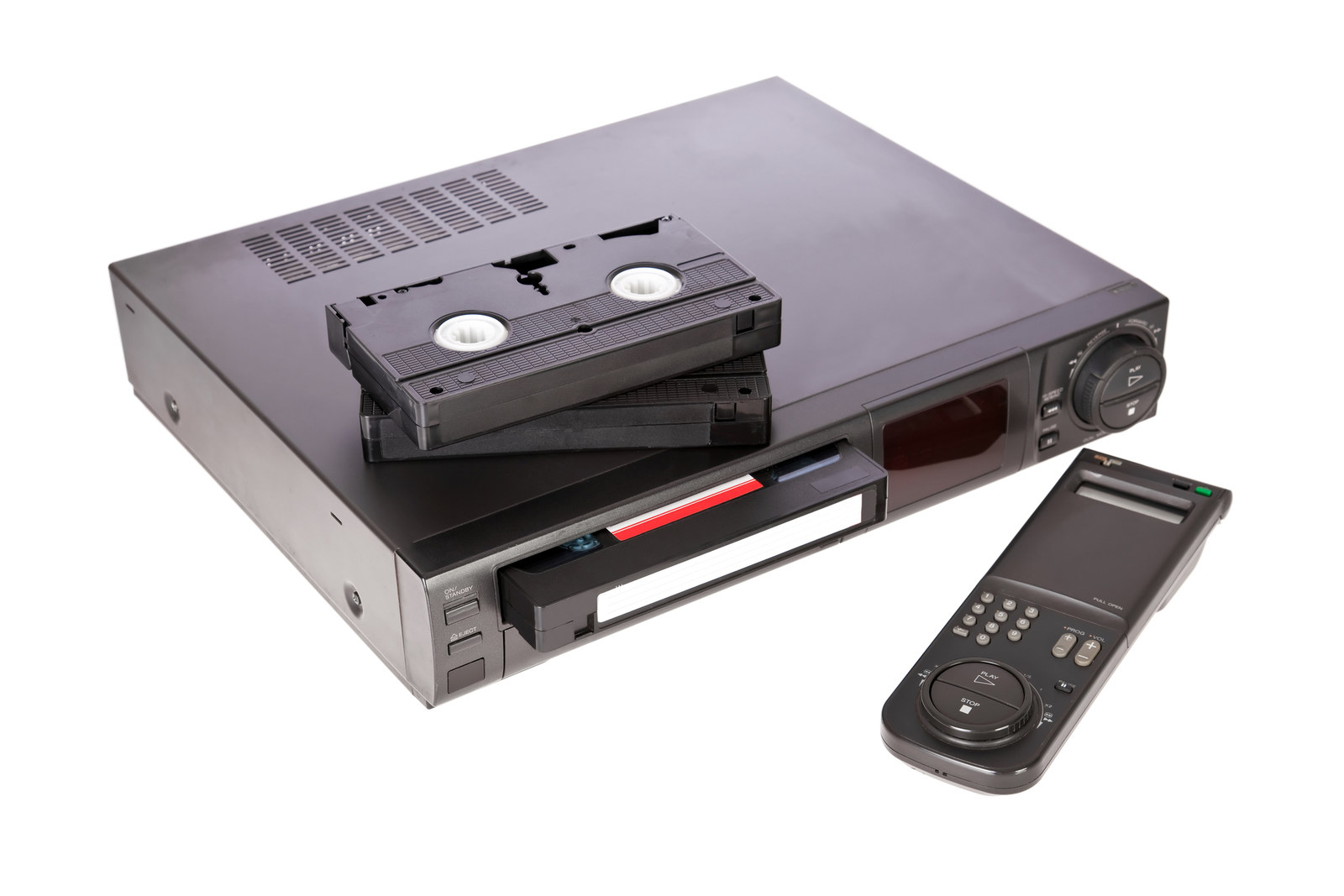 A stock photo of a VCR with VHS tape being ejected