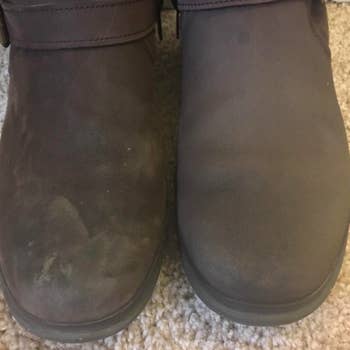 reviewer's suede brown boots next to each other, one dirty and scuffed, the other new looking