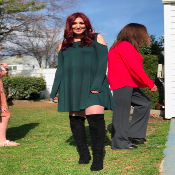 reviewer wears long sleeve dress with boots
