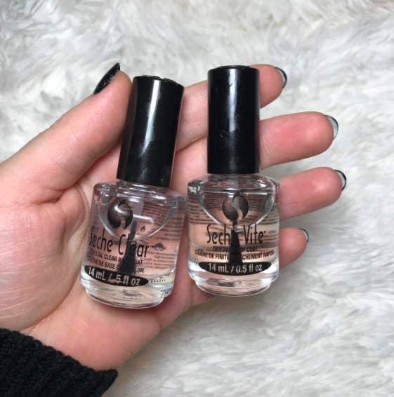 reviewer holds the two bottles of clear nail polish