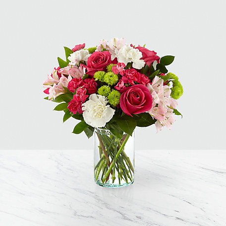 bouquet  of pink flowers in a clear vase