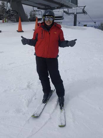 reviewer wearing the jacket in red while skiing
