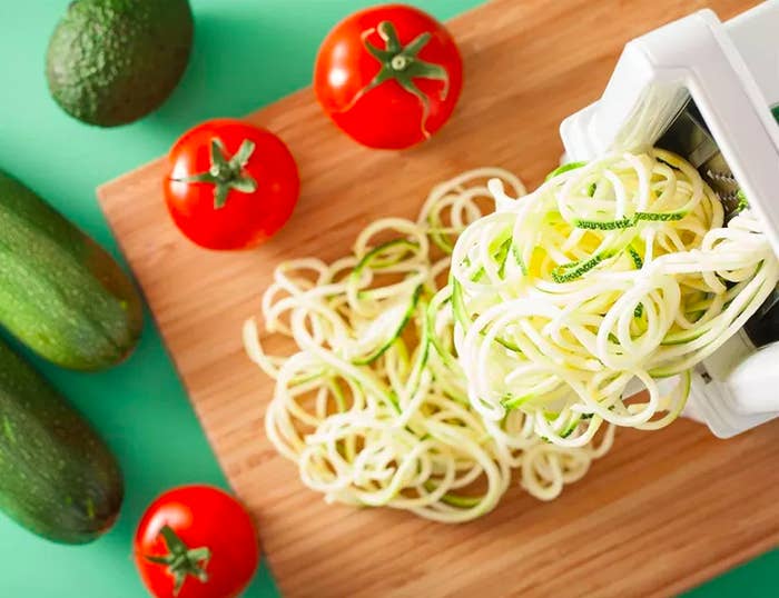 zucchini noodles coming out of the spiralizer 