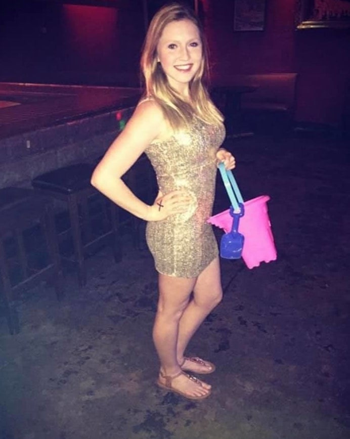 girl in a gold dress with bucket