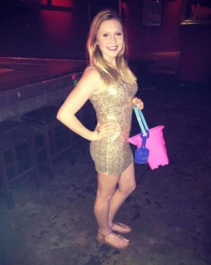 girl in a gold dress with bucket