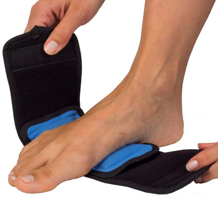 Person strapping the cold press onto the bottom of their foot 