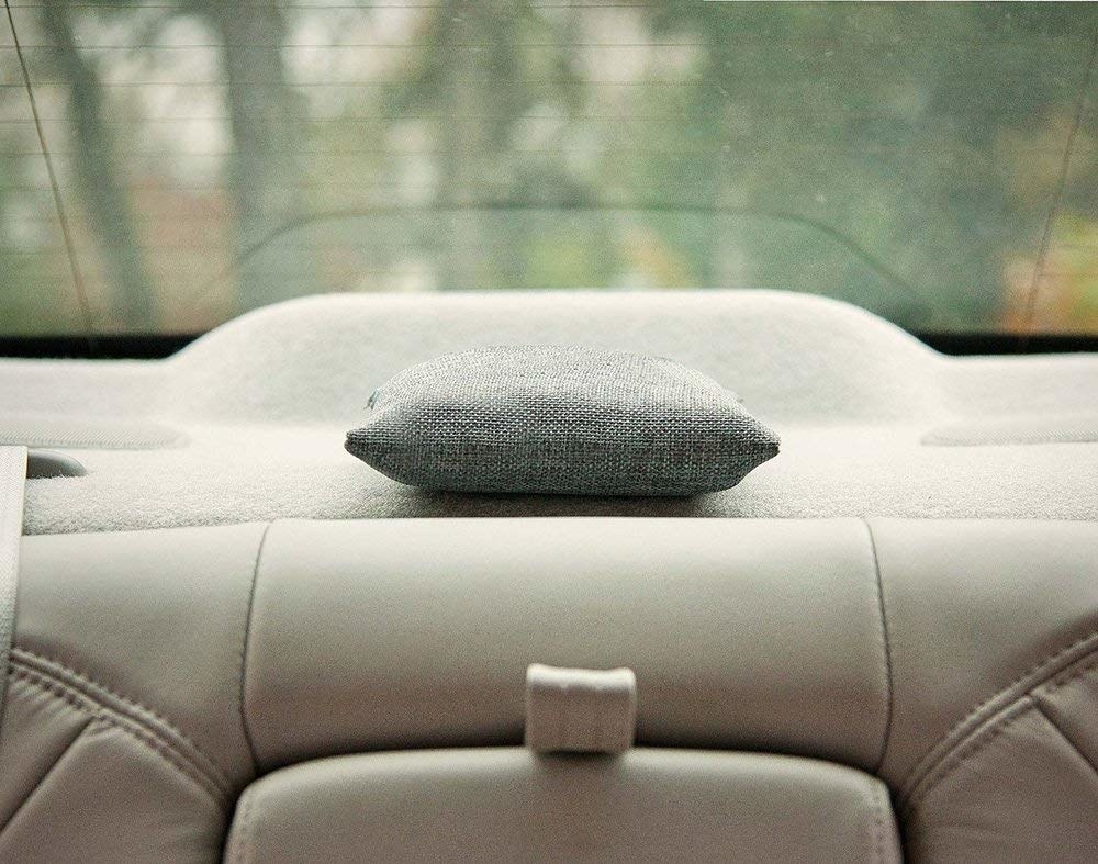 A charcoal bag on the back dashboard of a car