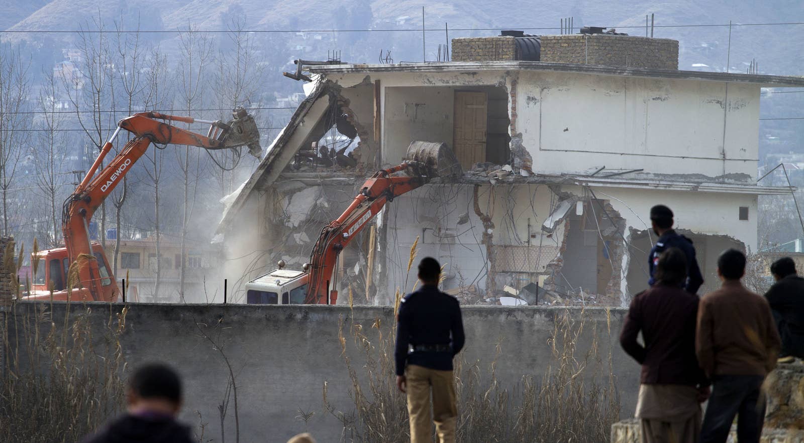 Pakistani authorities use heavy machinery to demolish the compound of Osama bin Laden in Abbottabad, Pakistan.
