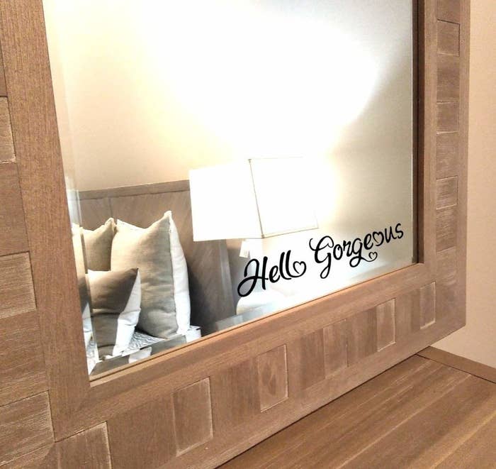 Black sticker that says &quot;Hello Gorgeous&quot; in cursive on a mirror