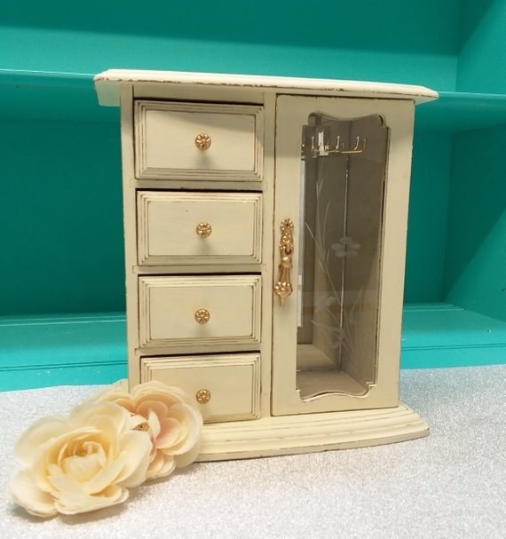 White dresser-style jewelry box with a glass door on the side