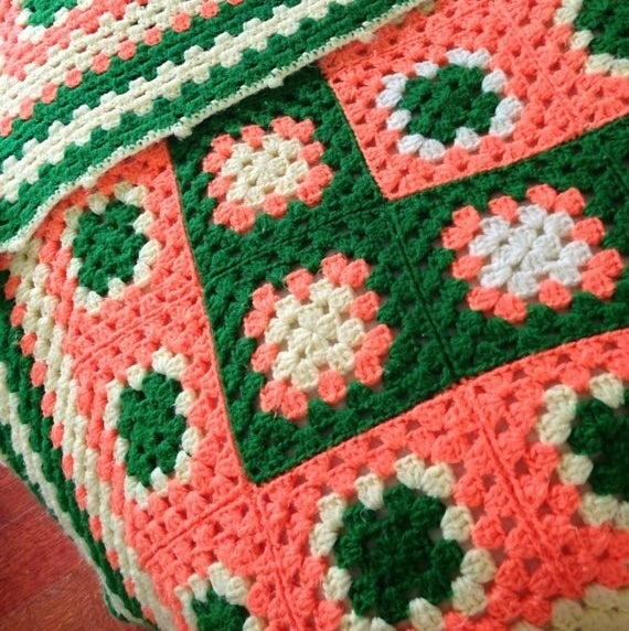 Green, pink, and white knitted blanket