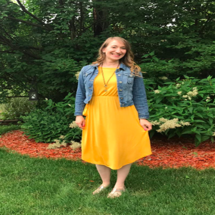 reviewer wears the dress in yellow with denim jacket 