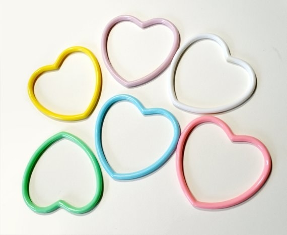 five different pastel-colored heart-shaped bracelets