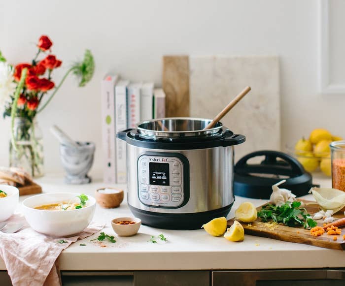 The Insta Pot with silver outside and black base and handles with an interface on the front