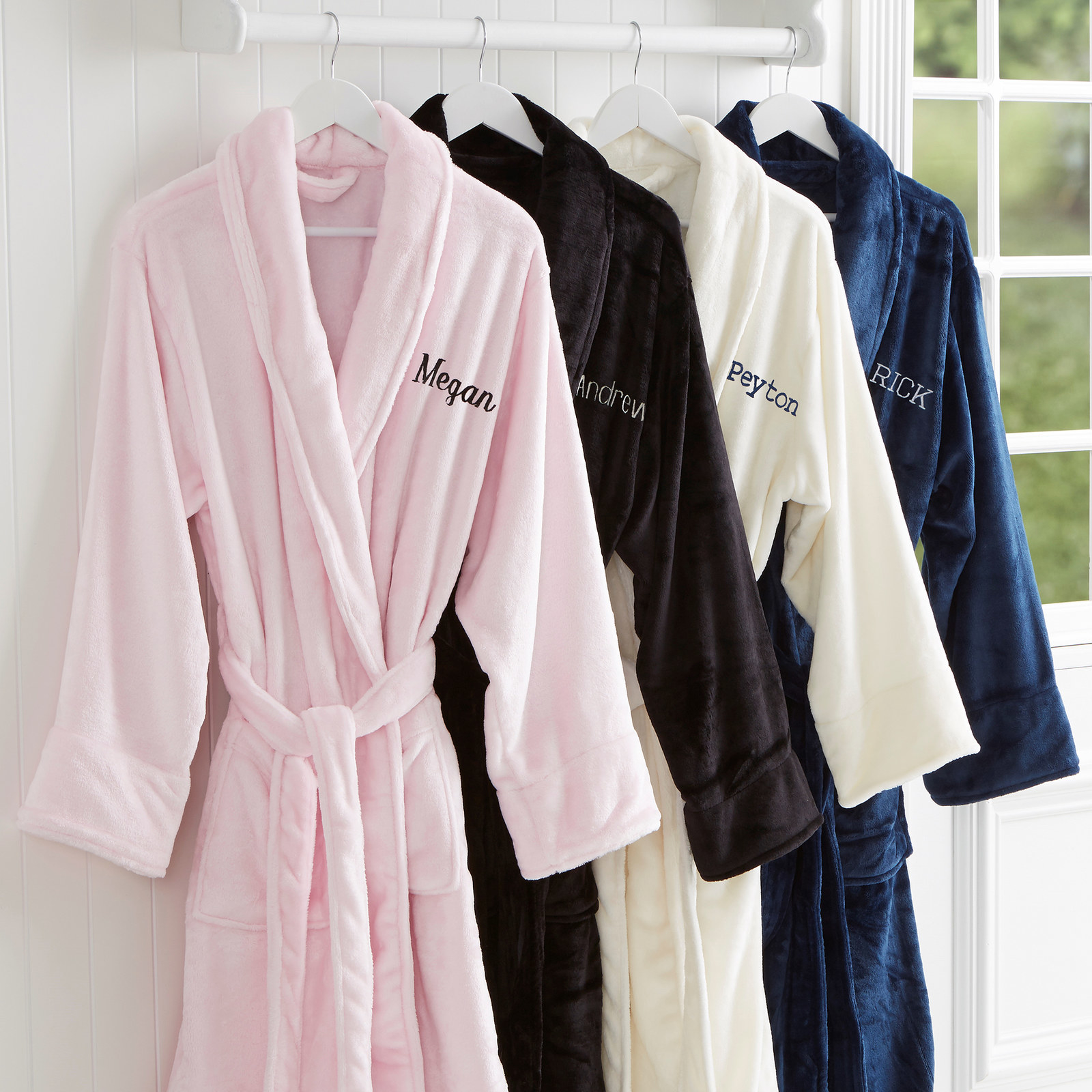 A pink, black, white, and blue robe with names embroidered on the left chest