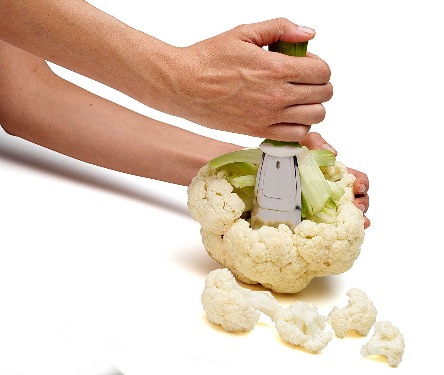 Hand using tool to chop cauliflower