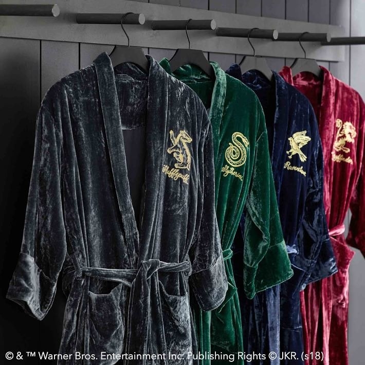 The velvet robes with house logos embroidered on the chests