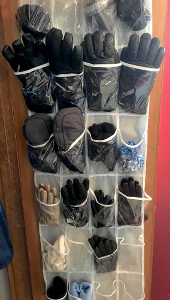 A reviewer's closet door with the organizer filled with gloves, one pair per slot