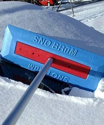 close-up of the sno brum removing snow