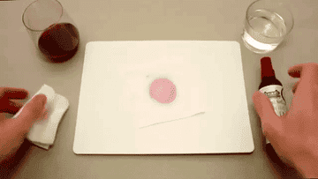Video showcasing how wine stain remover removes a stain from white fabric 