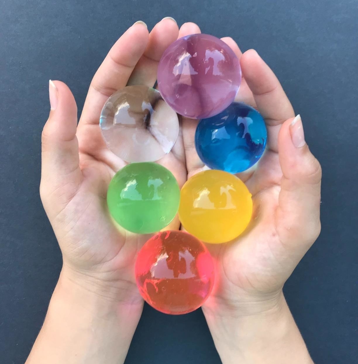 Amazon reviewer displays giant water beads in a variety of colors 