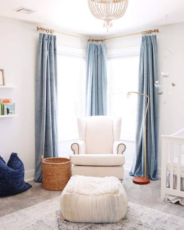 Reviewer&#x27;s nursery corner windows hung with three floor-to-ceiling blue velvet curtains