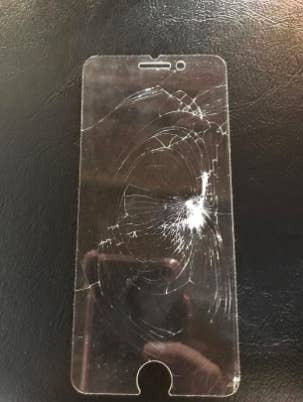 reviewer's pic of smashed up screen protector after reviewer dropped a 15 lb. dumbbell on their phone