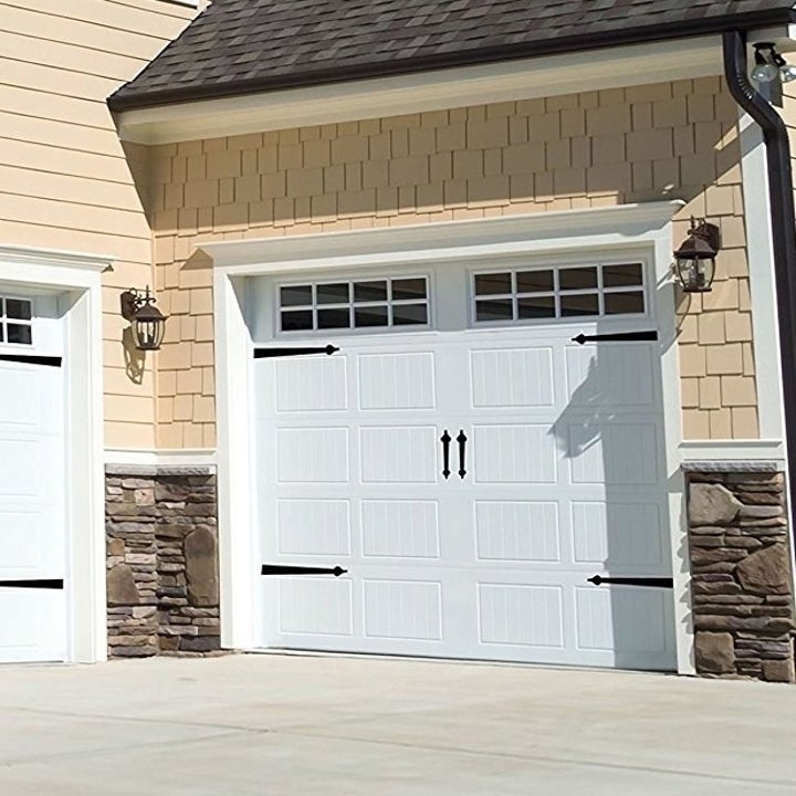 White garage with metal details added to look like carriage house door 