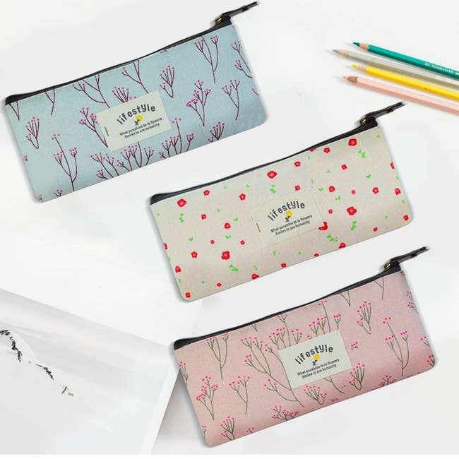 three floral printed zippered pouches