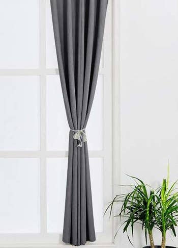 the curtains tied to the side in grey