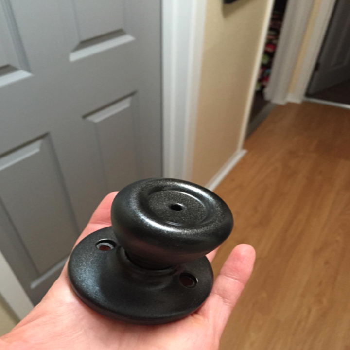 doorknob in reviewers palm looking like oil-rubbed bronze