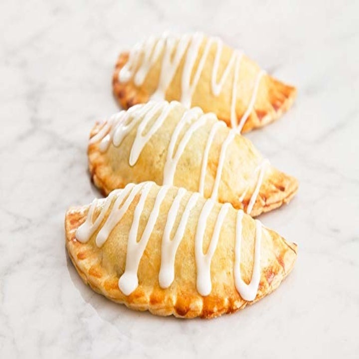 Empanadas baked and drizzled with frosting