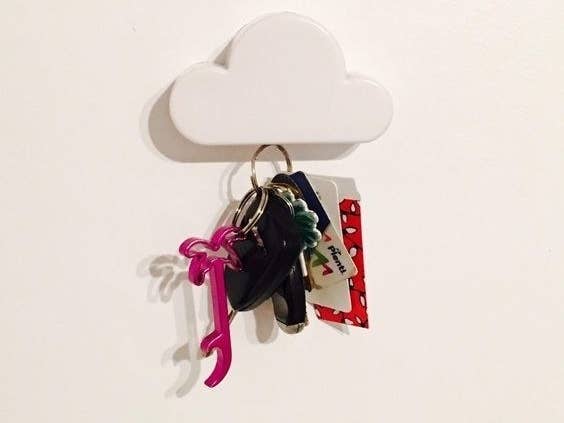 The cloud on a wall with a keychain hanging from it