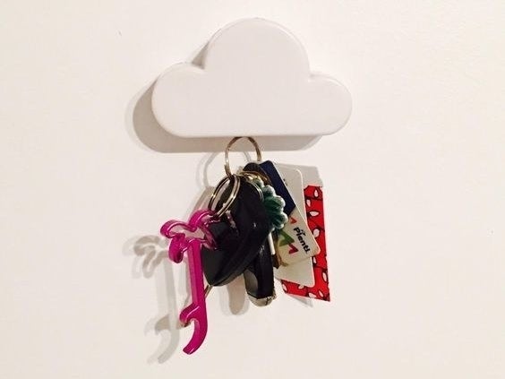 The cloud on a wall with a keychain hanging from it