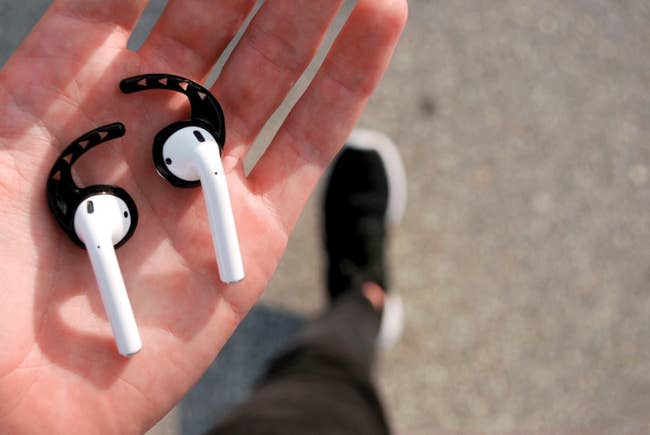 reviewer image of black air pod hooks on a pair of air pods