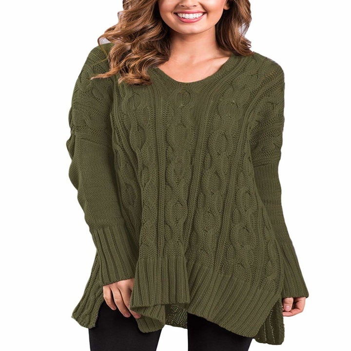 A model wearing the sweater in army green