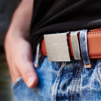 Model wearing the brown belt with a rectangular metal buckle