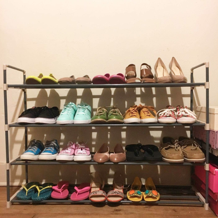 Reviewer&#x27;s four-shelf rack with 20 pairs of shoes lined up on it