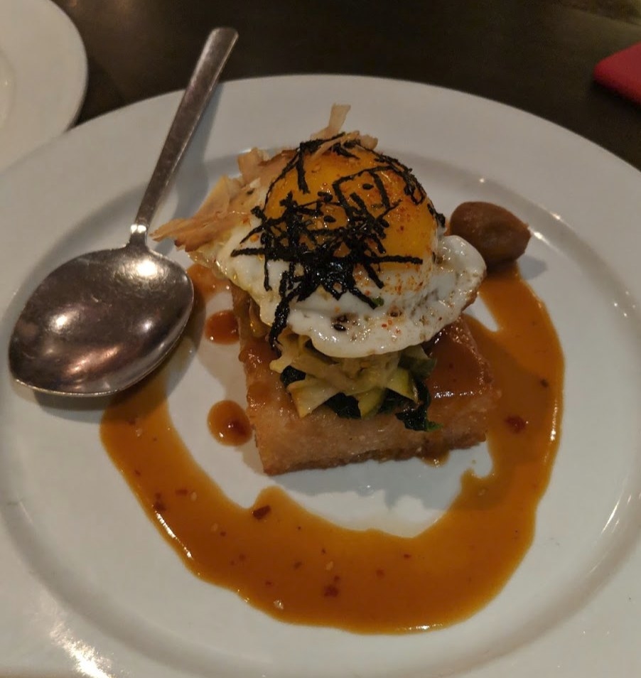 The unique dish, called Japanese "Bop," is a play on bibimbap with deep-fried, crispy dashi rice topped with an assortment of Asian pickles, togarashi, bonito, spinach, and sunny side up egg with umeboshi plum.