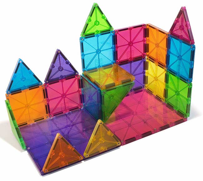 multicolored square and triangular magnetic tiles fashioned into a tower