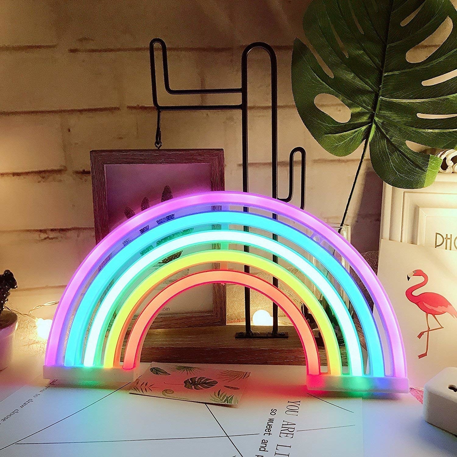 A neon rainbow light on a desk