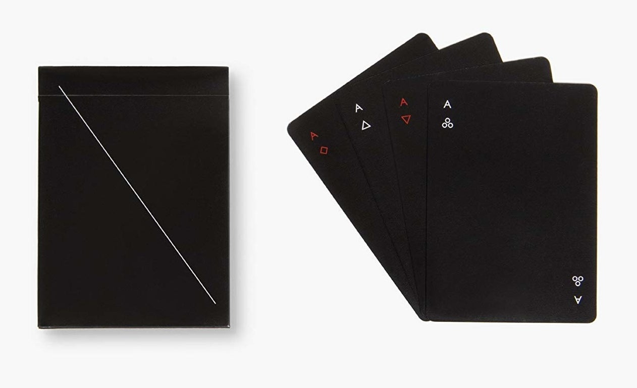 A set of black playing cards with simple red and white suit markers in the corners