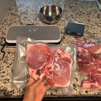 reviewer holding vacuum-sealed meat