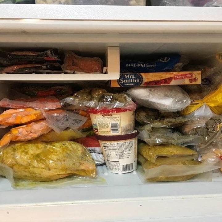 another reviewer showing all the vacuum sealed food they're able to store in their freezer